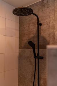 a shower with a shower head in a bathroom at De Hooiberg in Ritthem +31 photos