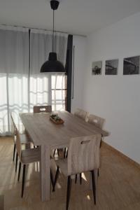 a wooden table and chairs in a living room at Apartament Lo Passador in Deltebre +12 photos