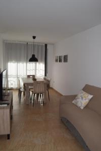 a living room with a couch and a table at Apartament Lo Passador in Deltebre