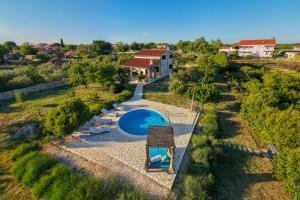 an aerial view of a villa with a swimming pool at Villa Stone Pearl with heated swimming pool in Sveti Filip i Jakov