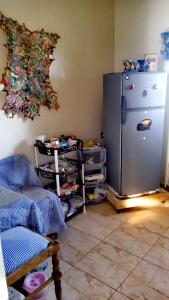 a kitchen with a refrigerator in the corner of a room at Villa Rabia in Sidi Kaouki