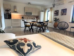 a kitchen and living room with a table and chairs at Apartments Maro in Senj