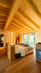 a bedroom with a bed and a large window at Le Case Resort in Macerata +55 photos