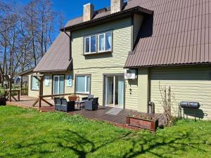 a house with a wooden deck in front of it at Meie Hiiumaa majutus Kärdlas in Kärdla