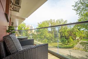 a balcony with chairs and a view of a street at Sas 1 Luxury Apartments in Mamaia