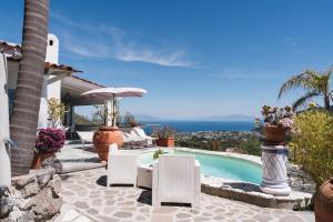 a villa with a swimming pool and a patio at Relais Villa Ettore in Barano d'Ischia