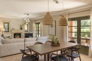 a living room with a table and chairs at Oleanna Villas - Villa Elena in Svoronata