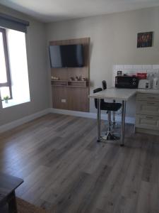 an empty living room with a desk and a table at Codladh Sámh Apartment No 1 in Templemore