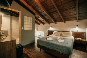 a bedroom with a bed and a bathroom with a shower at Ellafos Traditional Living-Elafonisi Couples Retreat in Elafonisi +175 photos