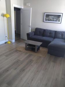 a living room with a couch and a coffee table at Codladh Sámh Apartment No 1 in Templemore