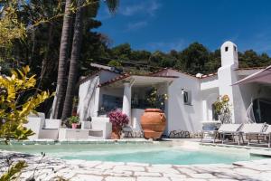 a house with a swimming pool and a villa at Relais Villa Ettore in Barano d'Ischia