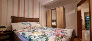 a bedroom with a bed with a floral comforter at Gemütliche Ferienwohnung am Randes des Wendlands in Schnega