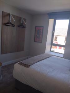 a bedroom with a large bed and a window at Codladh Sámh Apartment No 1 in Templemore