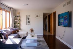 a living room with a couch and a table at 3BR Modern Apt • Gym • Workspace • Quiet Location in Chicago