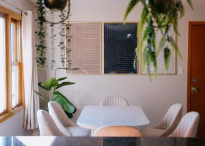 a dining room with a white table and chairs at 3BR Modern Apt • Gym • Workspace • Quiet Location in Chicago