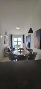 a living room with a table and chairs at Apartman Maja in Selce
