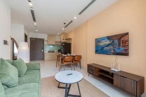 a living room with a couch and a table at Lucent Home in Gò Công
