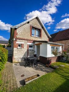 a brick house with a picnic table in the yard at La Petite Luce in Le Vaudreuil