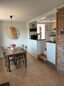 a kitchen and dining room with a wooden table and chairs at Casa utsikten in Uddevalla