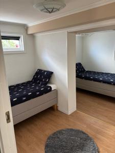 a room with two beds and a rug at Casa utsikten in Uddevalla
