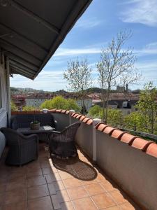 a balcony with two chairs and a table on a balcony at Casa utsikten in Uddevalla