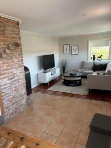 a living room with a couch and a tv at Casa utsikten in Uddevalla