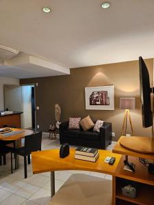 a living room with a couch and a table at Flat na praia da Barra 2 in Rio de Janeiro