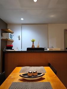 a table with a plate of cupcakes on top of it at Flat na praia da Barra 2 in Rio de Janeiro