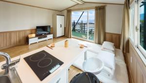 a living room with a table and a large window at Gurye Jirisan Hosu Resort Pension in Gurye