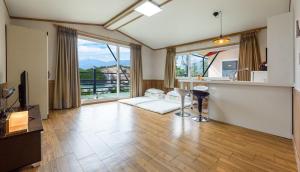 a large living room with a couch and a kitchen at Gurye Jirisan Hosu Resort Pension in Gurye +32 photos