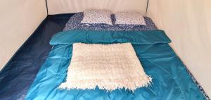 a bed in a tent with two pillows on it at Free People Bungalow & Cort in Vama Veche +59 photos