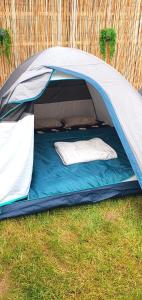 a blue and white tent with two pillows in it at Free People Bungalow & Cort in Vama Veche