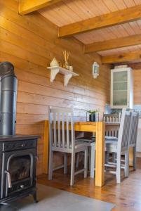 a dining room with a fireplace and a table and chairs at Domek BB in Podgórzyn +22 photos