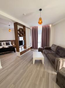 a living room with a couch and a coffee table at The Honeycomb Boutique Hotel in Golem