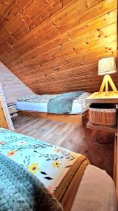a bedroom with a bed and a wooden ceiling at Domek BB in Podgórzyn