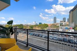 a balcony with yellow chairs and a view of a city at Million Dollar Fireworks View no 412 in Dallas