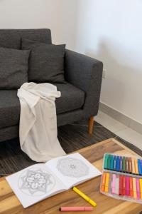 a living room with a couch and a table with drawings at HOMEFULL Apartamentos in Salta