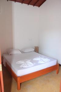Ein Bett oder Betten in einem Zimmer der Unterkunft Pousada Paraíso dos Ipês