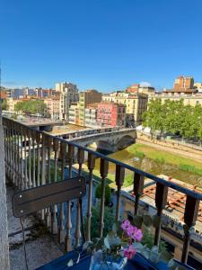 a balcony with a view of a river and buildings at Rambla Riverview in Girona