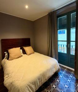 a bedroom with a large bed and a window at Rambla Riverview in Girona
