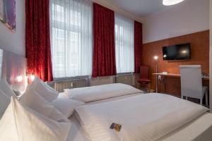 Postel nebo postele na pokoji v ubytování Hotel Stadtkrug