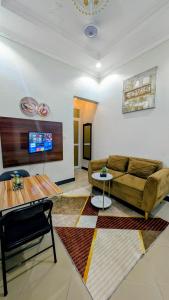a living room with a couch and a table at Merota Apartment in Dar es Salaam