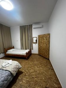 a bedroom with two beds and a window at Guest house Lori in Pogradec