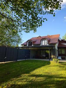a house with a fence and a yard at Villa ENT in Bihać
