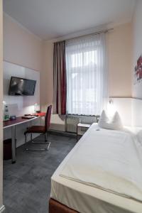 Postel nebo postele na pokoji v ubytování Hotel Stadtkrug