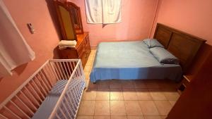 a small bedroom with a bed and a window at Vacances agréables c'est ici in Les Abymes