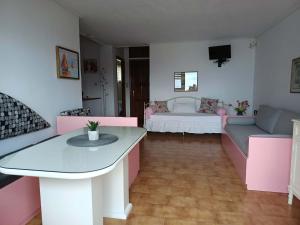 a living room with a table and a couch at Ostria Apartments Kalives in Kalyves