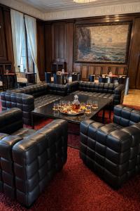 a room with couches and a table and chairs at Villa Weisser Berg in Neuwied