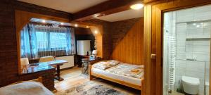 a bedroom with a bed and a bathroom with a shower at Apartamenty u drwala in Zakopane