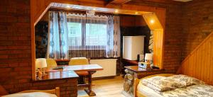 a room with a desk and a window in a room at Apartamenty u drwala in Zakopane